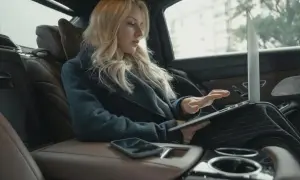 Kobieta w samochodzie sprawdza, czy można zarejestrować samochód online.